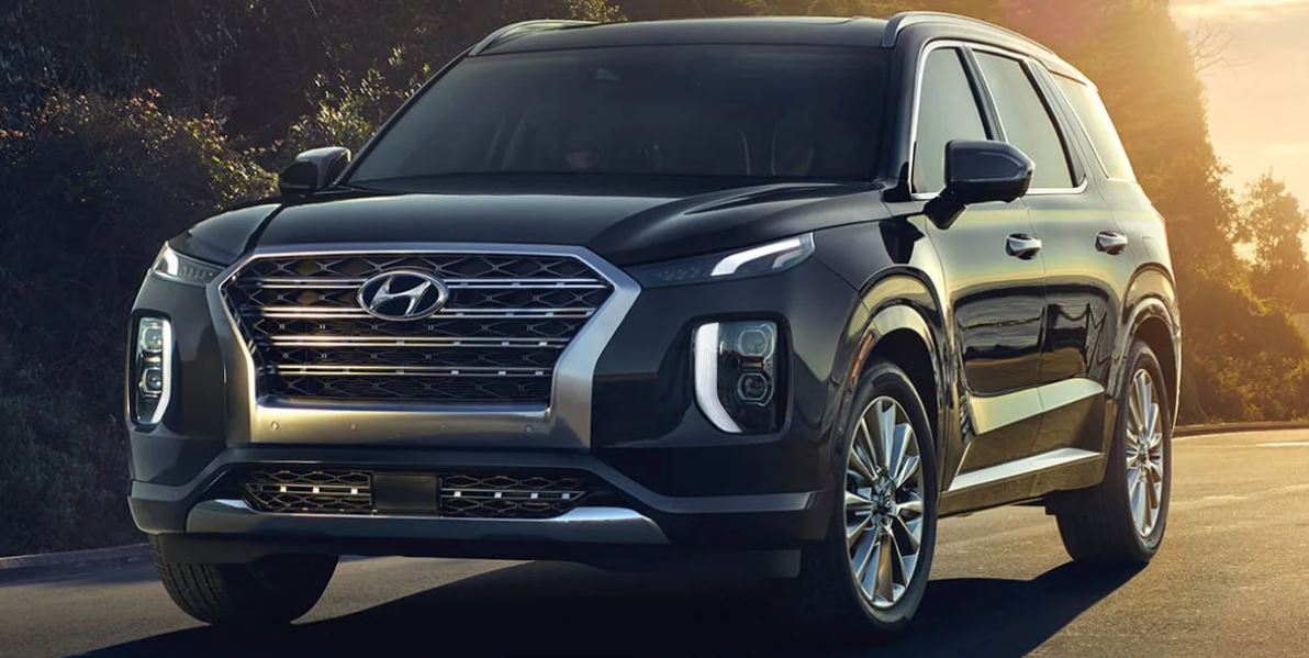 Front view of a black Hyundai SUV on a road at sunset, symbolizing engine reliability.