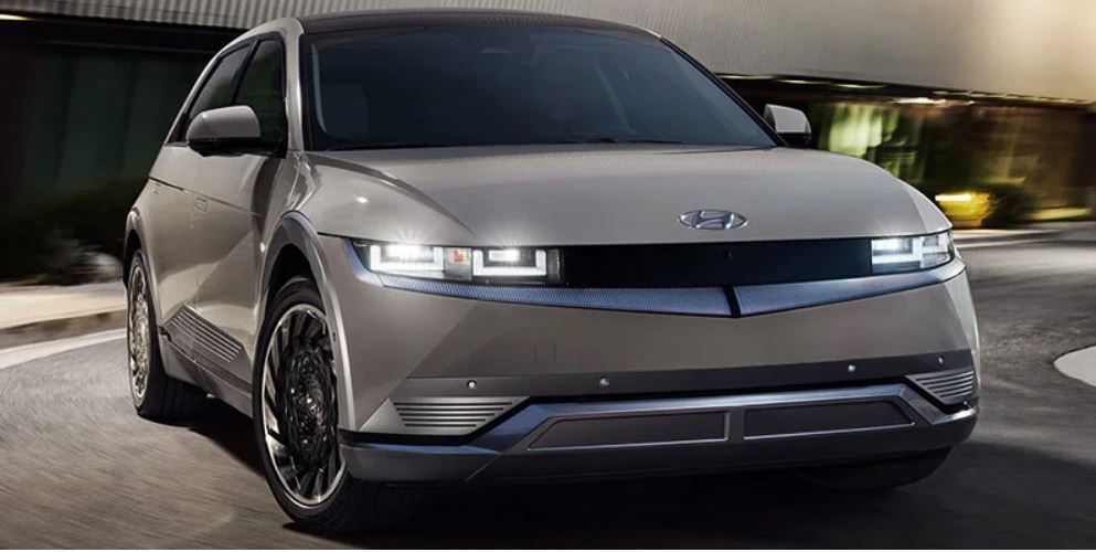 Front view of a Hyundai IONIQ 5 with headlights on at night