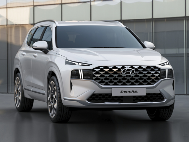 A white 2023 Hyundai Santa Fe SUV parked in front of a glass building, representing reliability and expert vehicle diagnostics