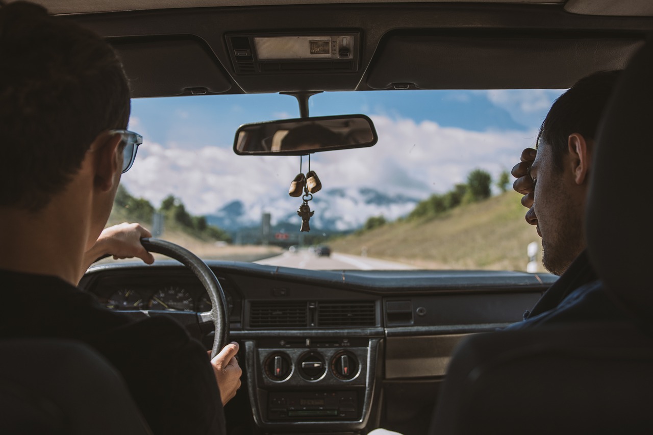 Two people driving through scenic mountain roads, representing weekend getaways from North Little Rock, AR
