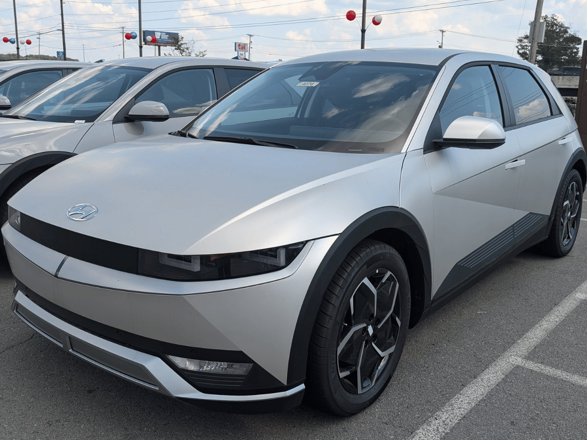 Silver 2025 Hyundai Ioniq 5 electric SUV on display at Crain Hyundai of North Little Rock in a dealership parking lot