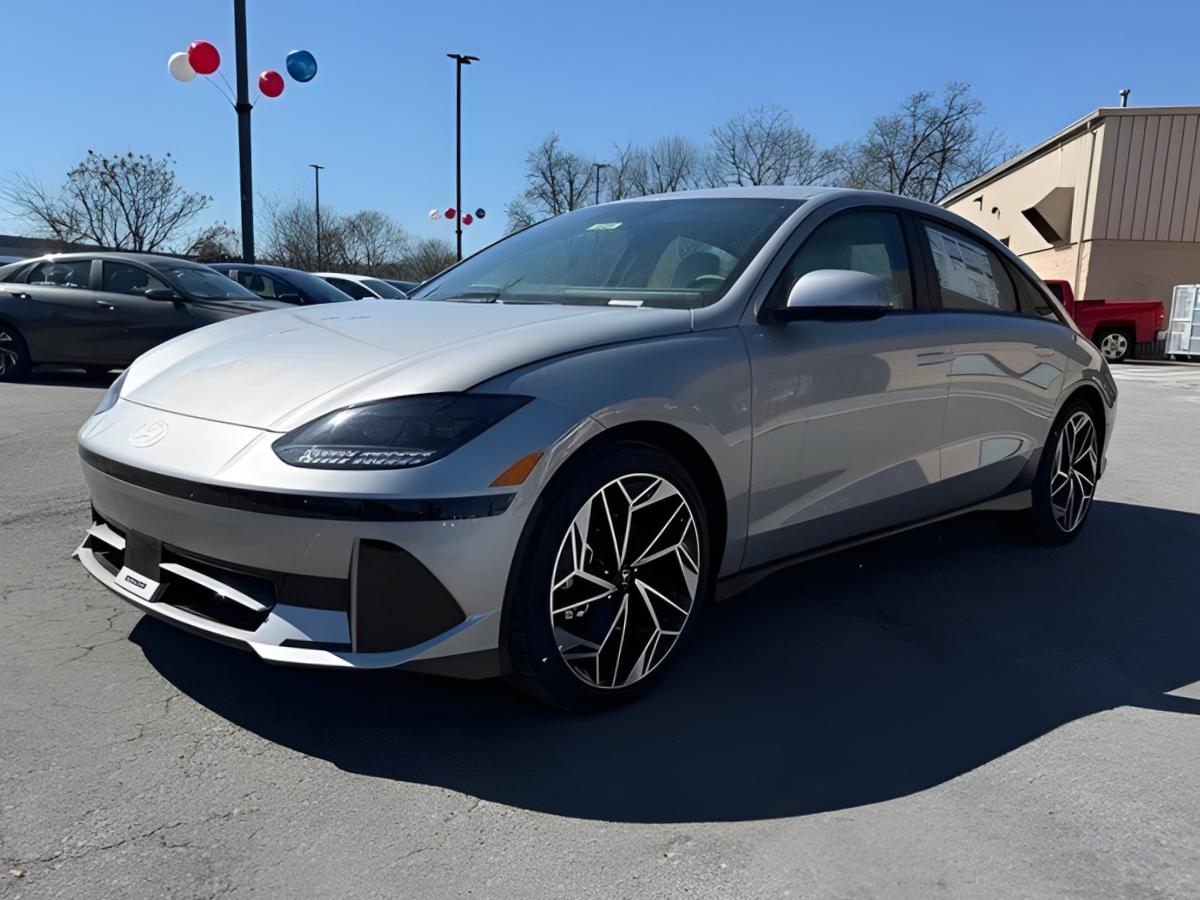 Silver Hyundai IONIQ 6 electric sedan parked at Crain Hyundai of North Little Rock dealership under a clear blue sky