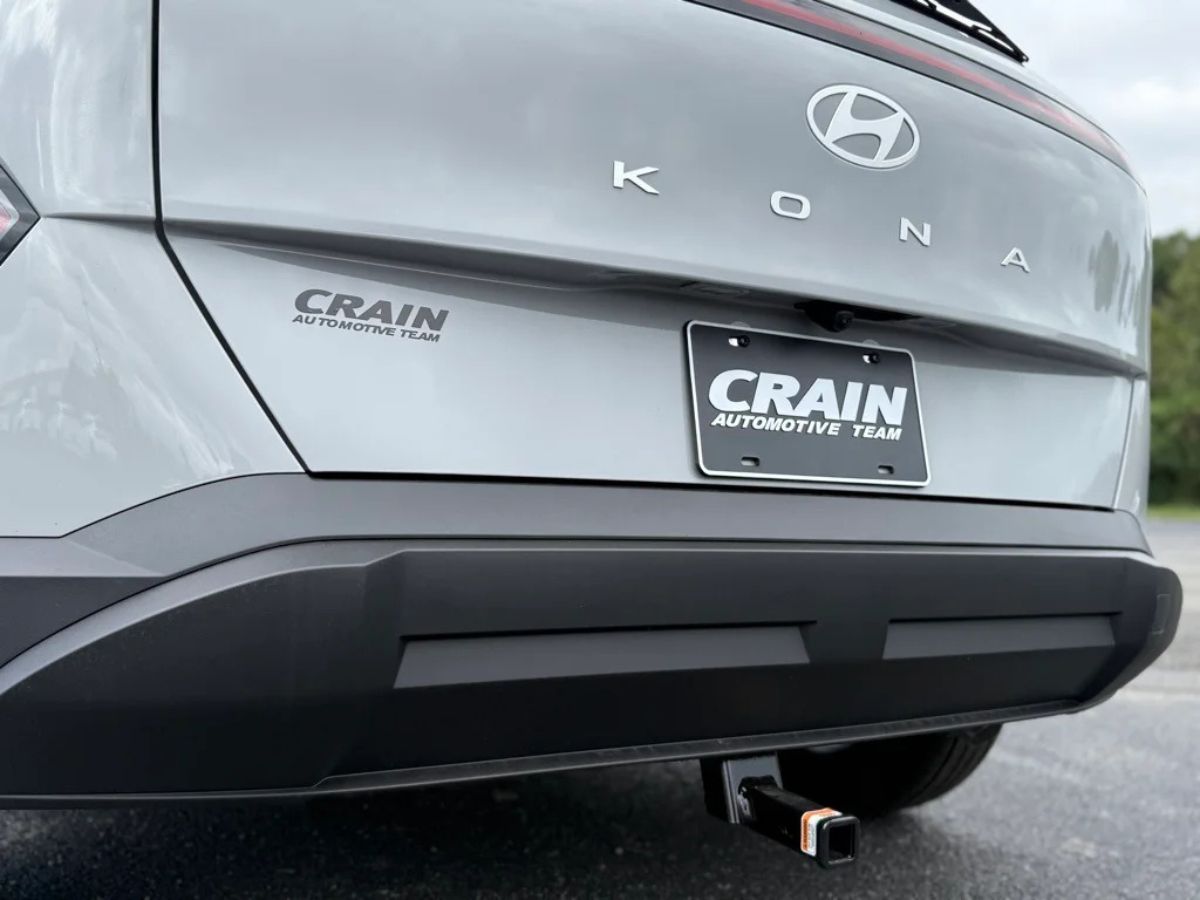Rear view of a silver Hyundai Kona at Crain Hyundai of North Little Rock, featuring dealership branding and a clean modern design.